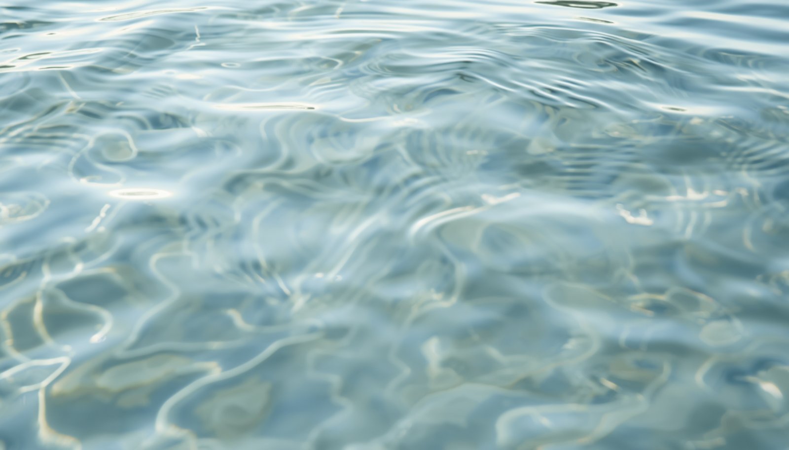 Calm water surface in slate-blue and cream tones